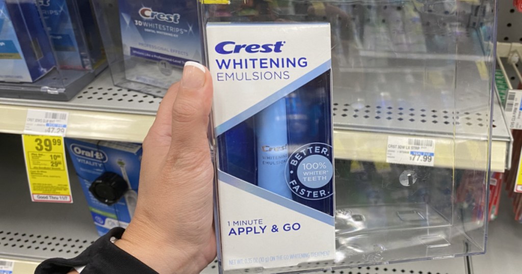 hand holding crest whitening product