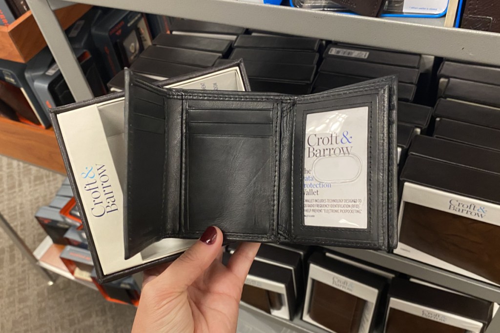 hand holding a black men's tri fold wallet open at kohl's
