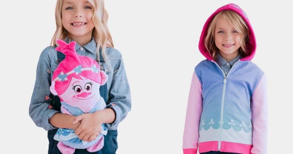 girl holding a plush next to a girl in a sweatshirt