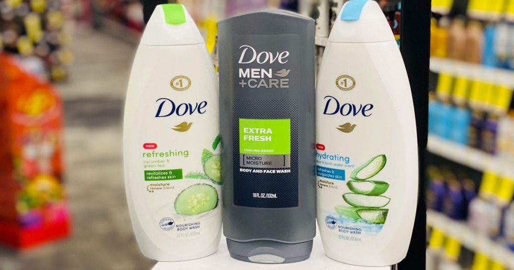 two white bottles of dove women's body wash and one grey bottle of dove men's body wash on white table at cvs