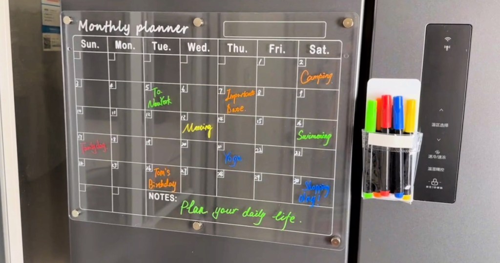 monthly Acrylic Calendar displayed on refrigerator next to markers 