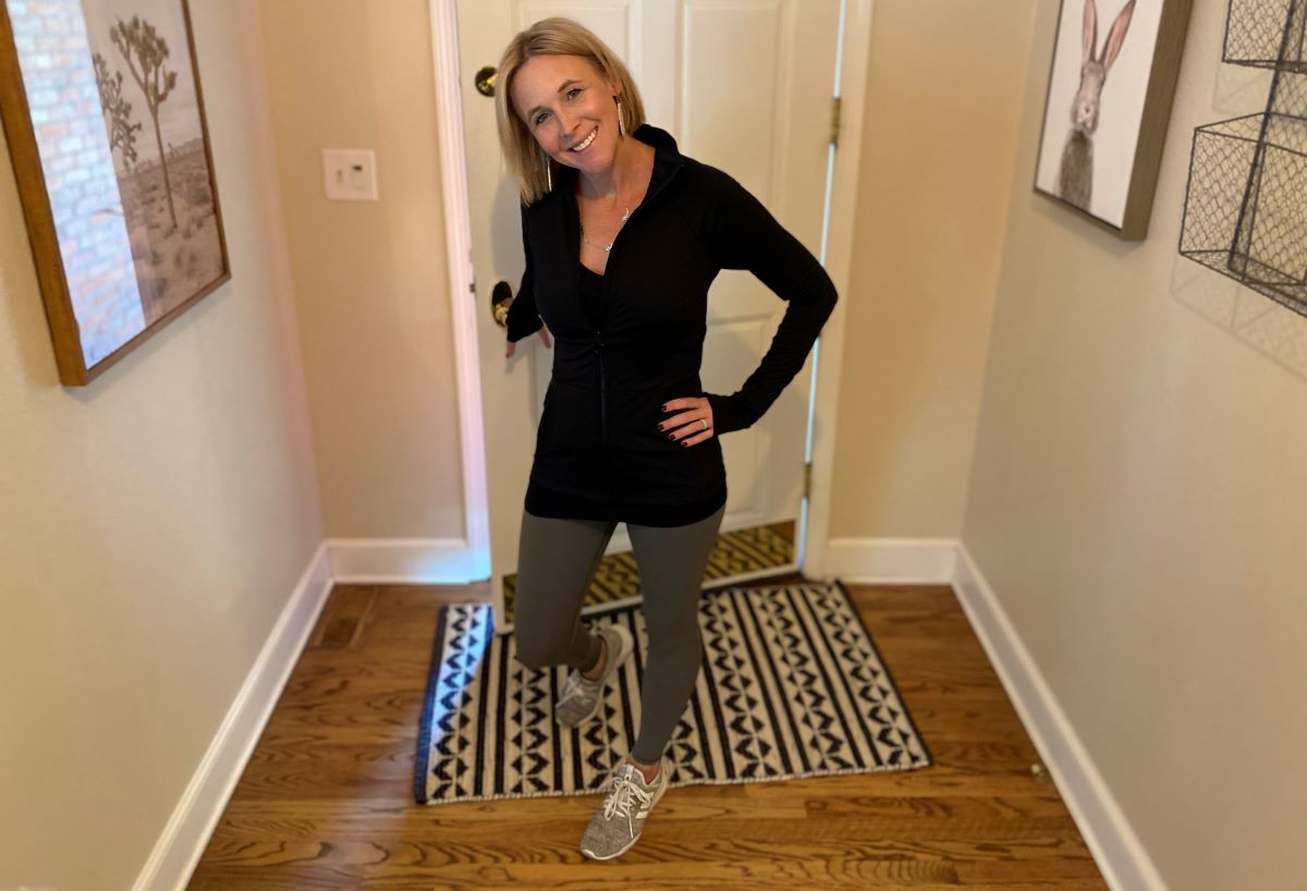 woman standing by a door wearing Fabletics leggings