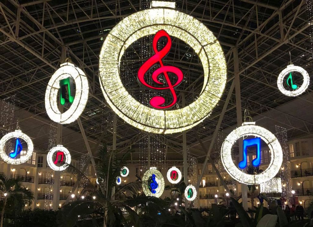 music notes hanging from ceiling lit up in christmas lights at Gaylord Opryland hotel