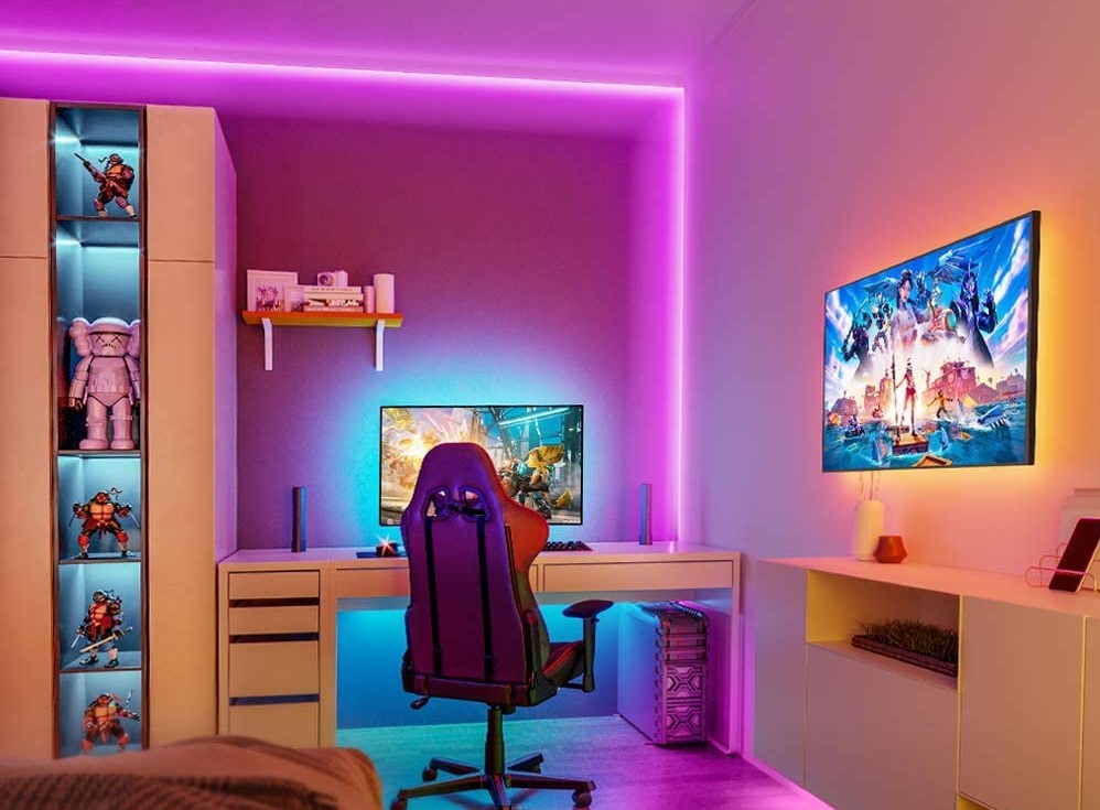 room with LED lights on the wall and a desk area