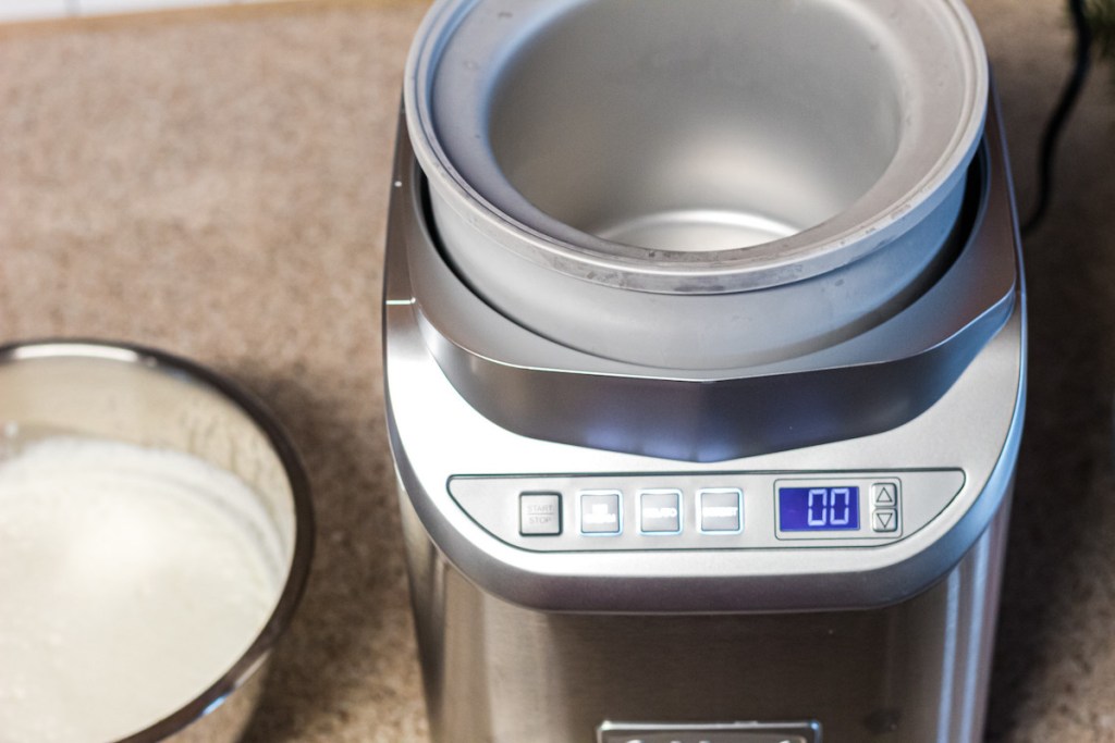 cuisinart ice cream maker on counter next to stainless steel bowl