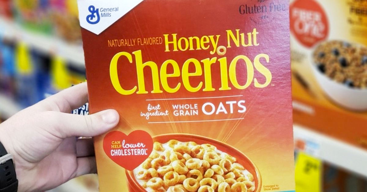 person holding up a box of honey nut Cheerios