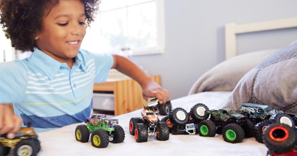 kid playing with Hot Wheels Monster Demo Doubles Trucks 2-Pack