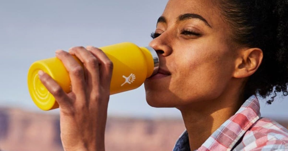 Woman drinking from Hydro Flask bottle