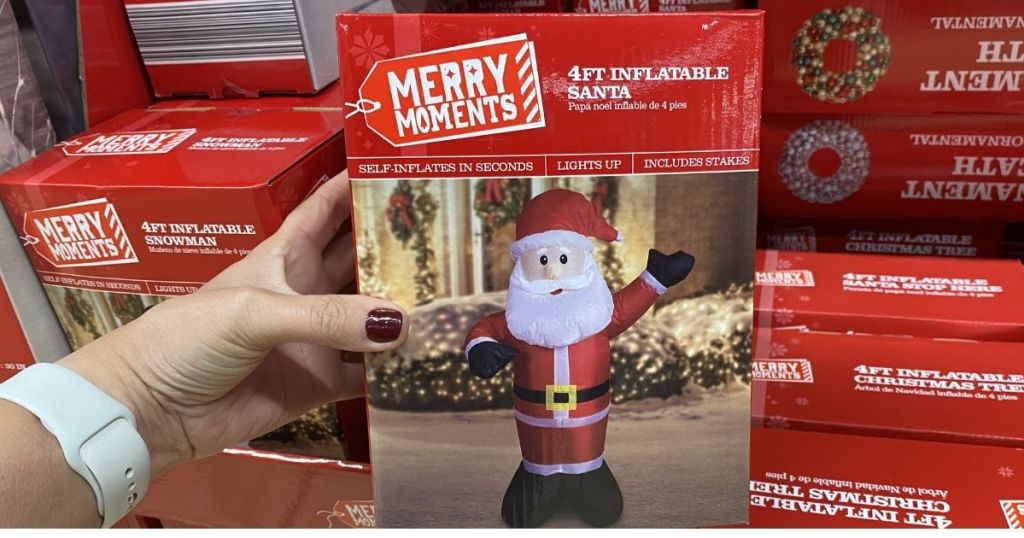 Hand holding Merry Moments Santa InflataBle