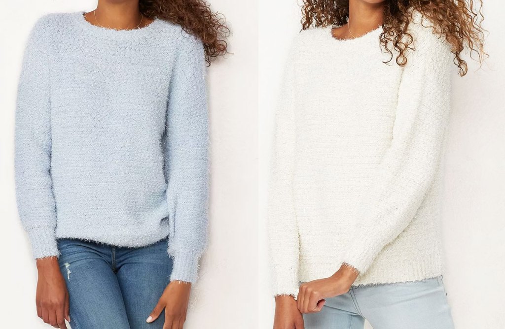 two women modeling fuzzy pullover sweater in light blue and cream colors