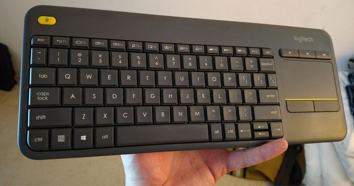 Hand holding Logitech Keyboard