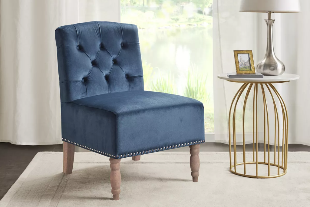 blue accent chair next to a side table