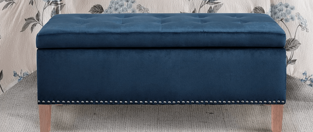 storage ottoman in front of a bed
