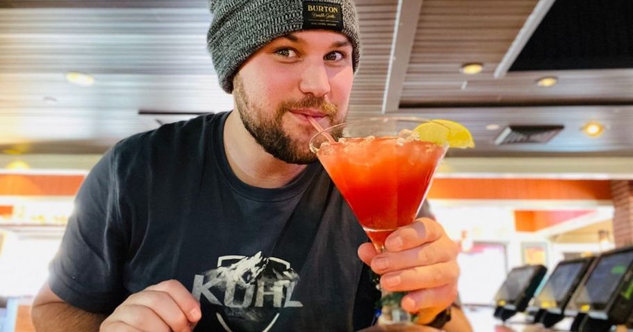 Man drinking the Merry Berry margarita