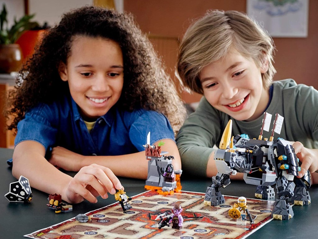 two kids playing with LEGOs at table