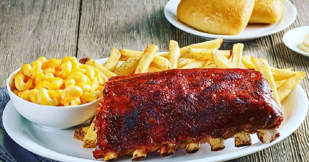 ribs, fries, and mac n cheese on plate and two rolls on small plate