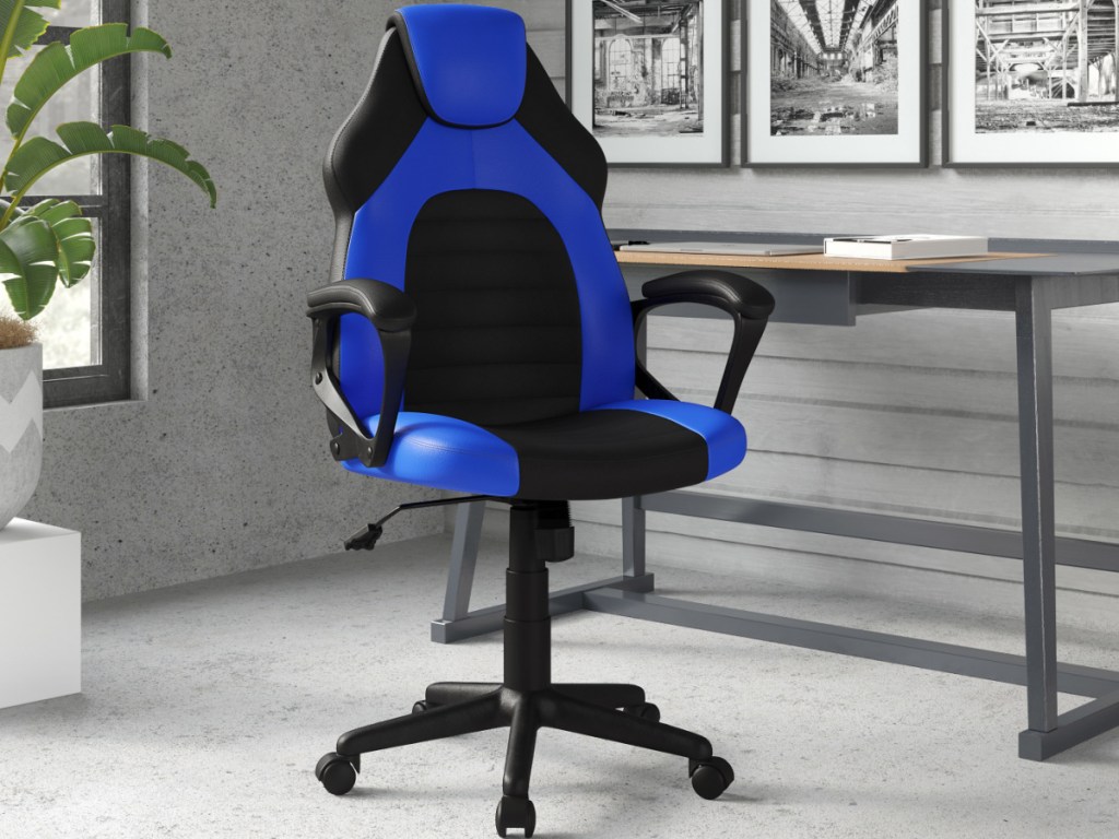 blue and black gaming chair sitting in an office next to a desk