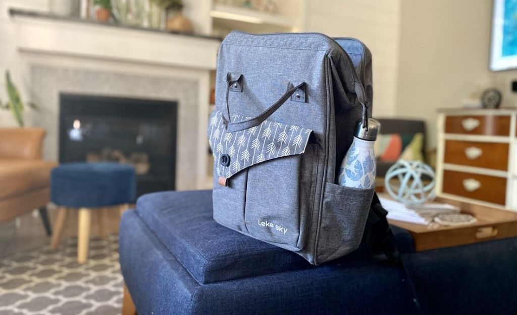 A backpack on an ottoman in a living room
