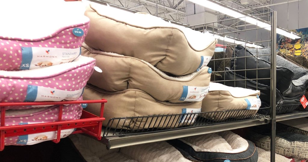 various pet beds stacked on shelf at petsmart