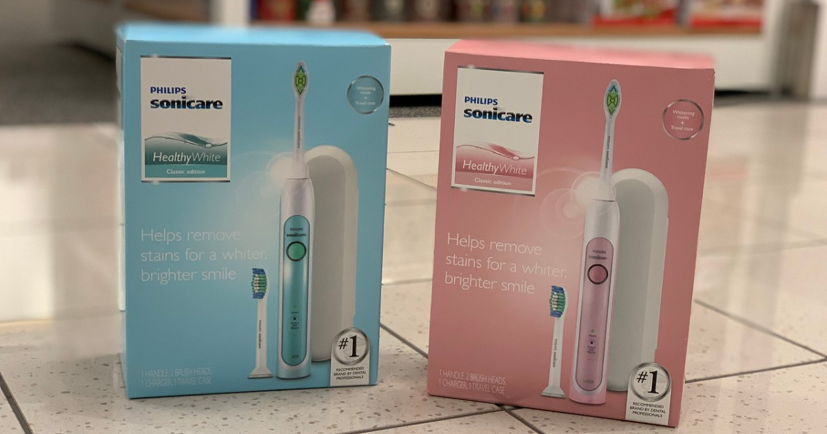 one blue electric toothbrush box and one pink electric toothbrush box on store floor