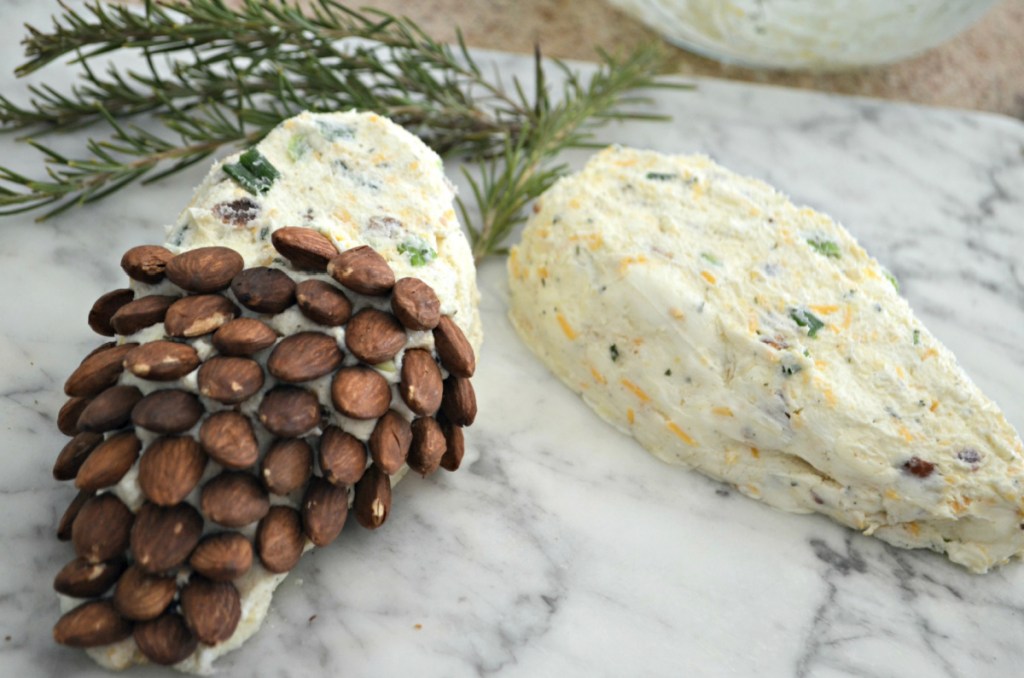 A pinecone cheeseball made with almonds, bacon, ranch, and cheddar