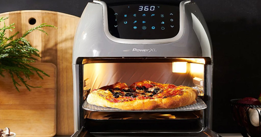 grey power vortex air fryer on kitchen counter with it's door open showing a pizza inside