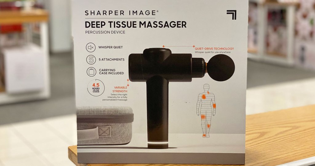 sharper image massage gun in box on a wood display table at kohl's