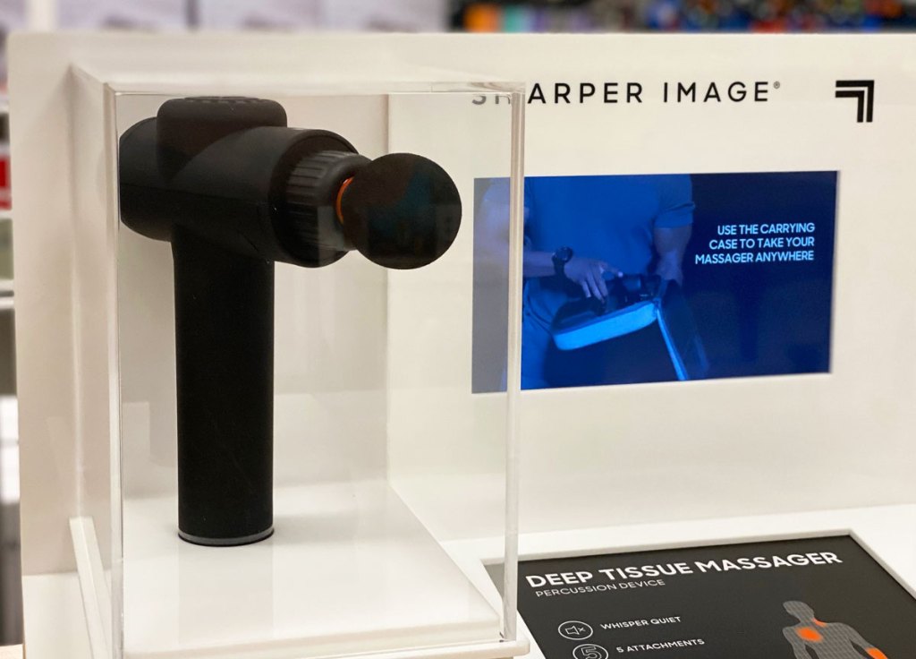 black sharper image massage gun in a display case at kohl's