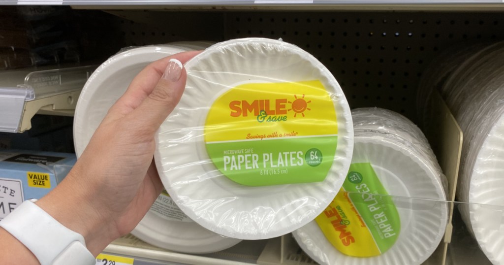 hand holding paper plates