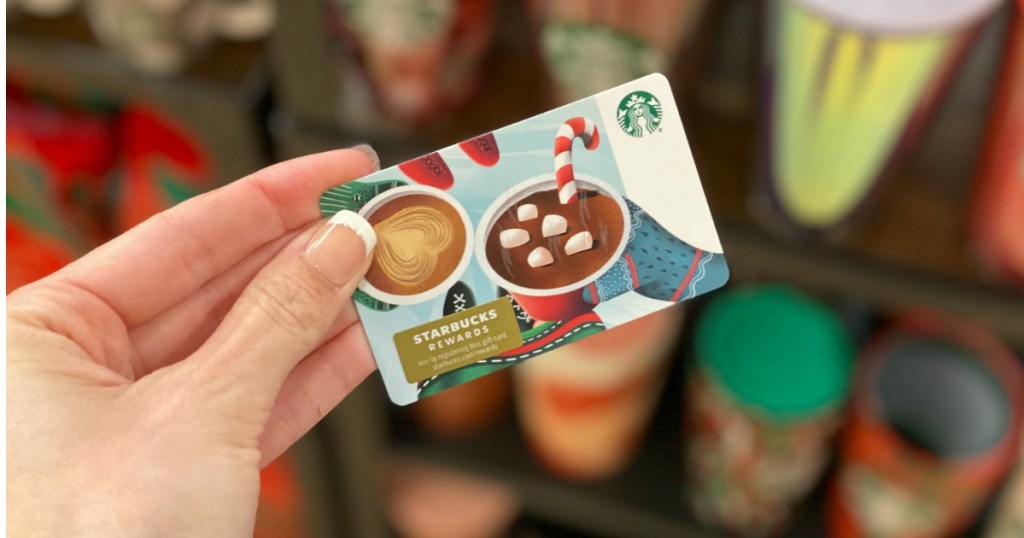 Woman holding up Starbucks Gift Card