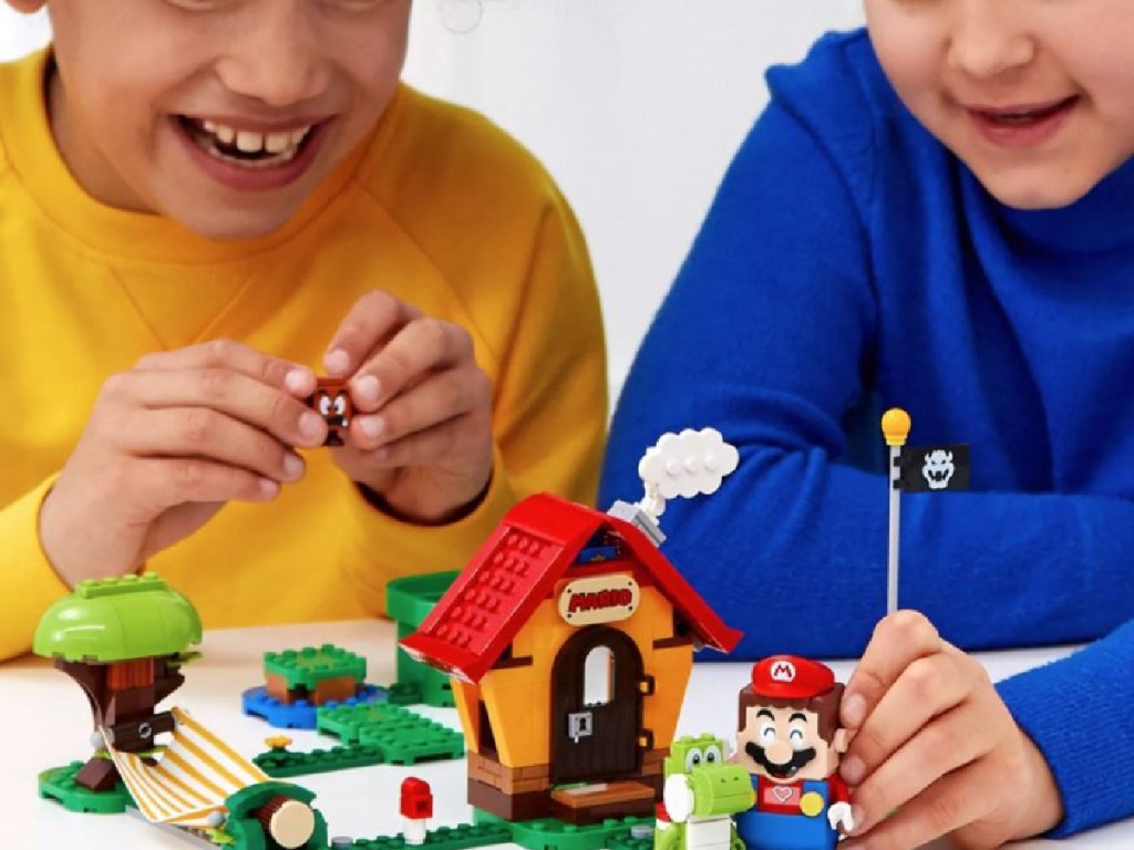 kids playing with small LEGO house