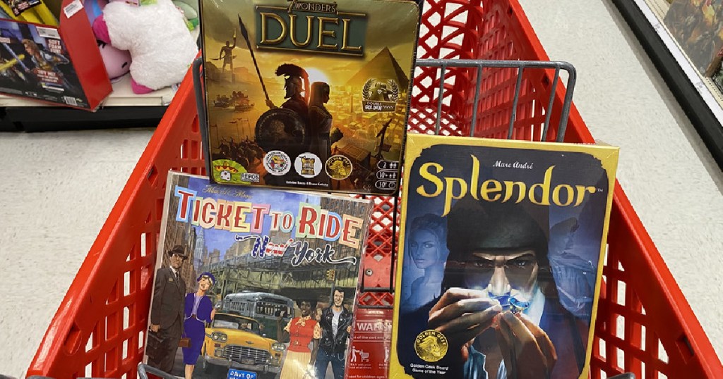 board games in red shopping cart in store