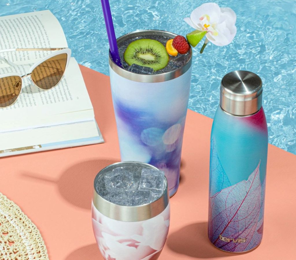 Tervis tumblers and water bottle on a table by a pool