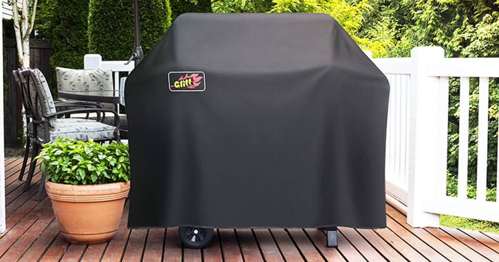 black grill cover over propane grill on deck next to potted plant