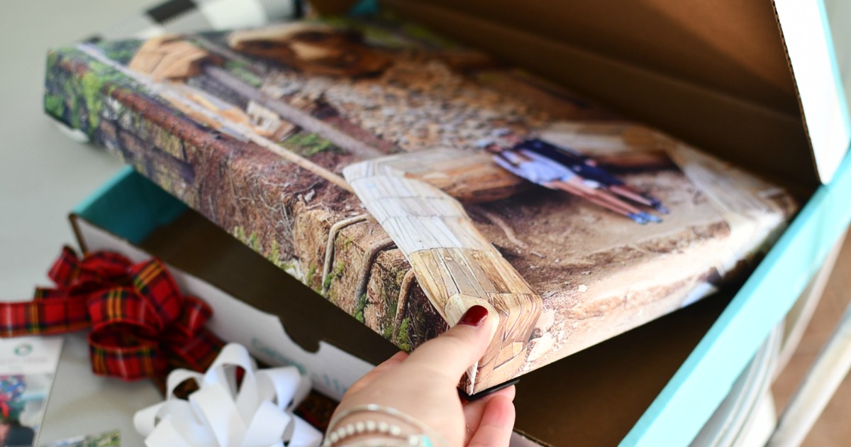 woman taking photo canvas out of box