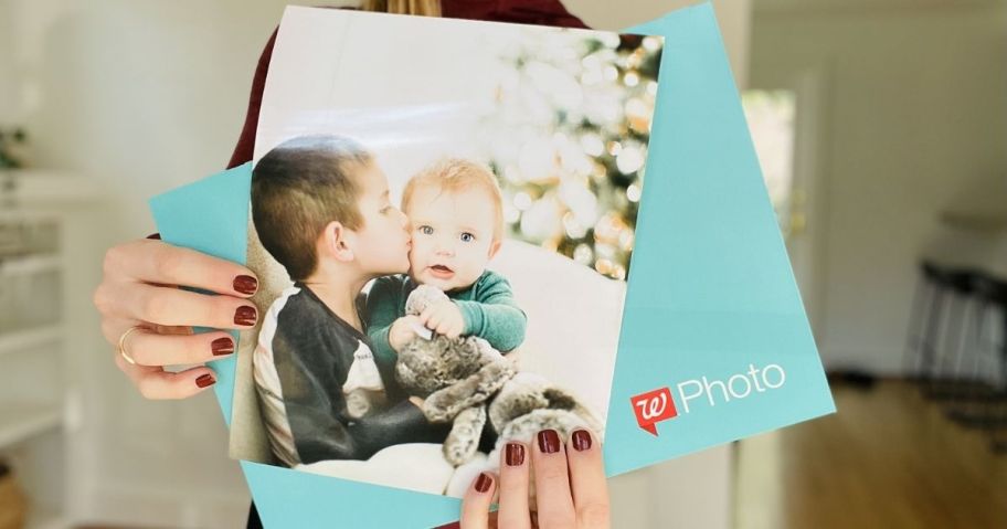 hand holding a Walgreens photo print and envelope