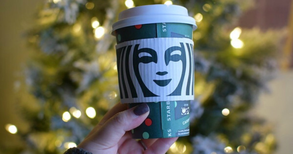 Woman Holding up Starbucks Cup