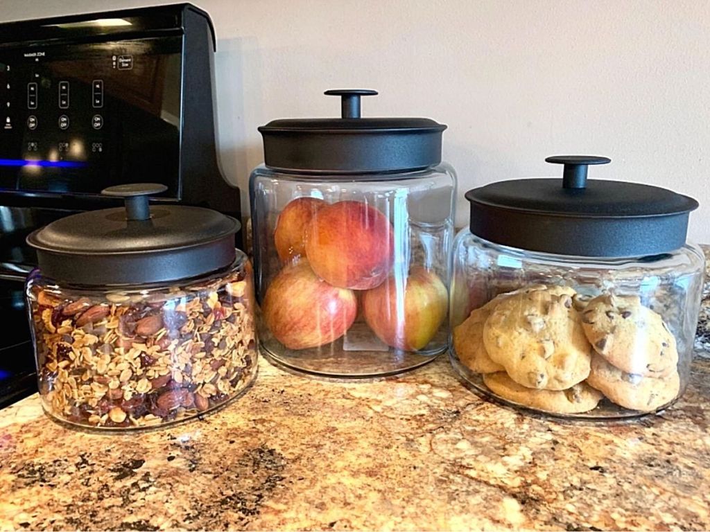 three glass jars with black lids