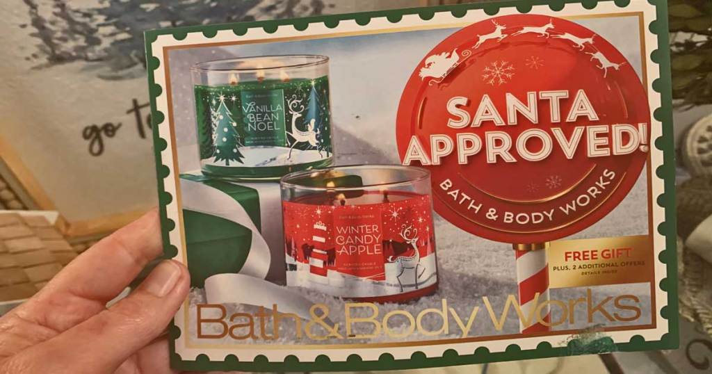 hand holding a bath and body works mailer