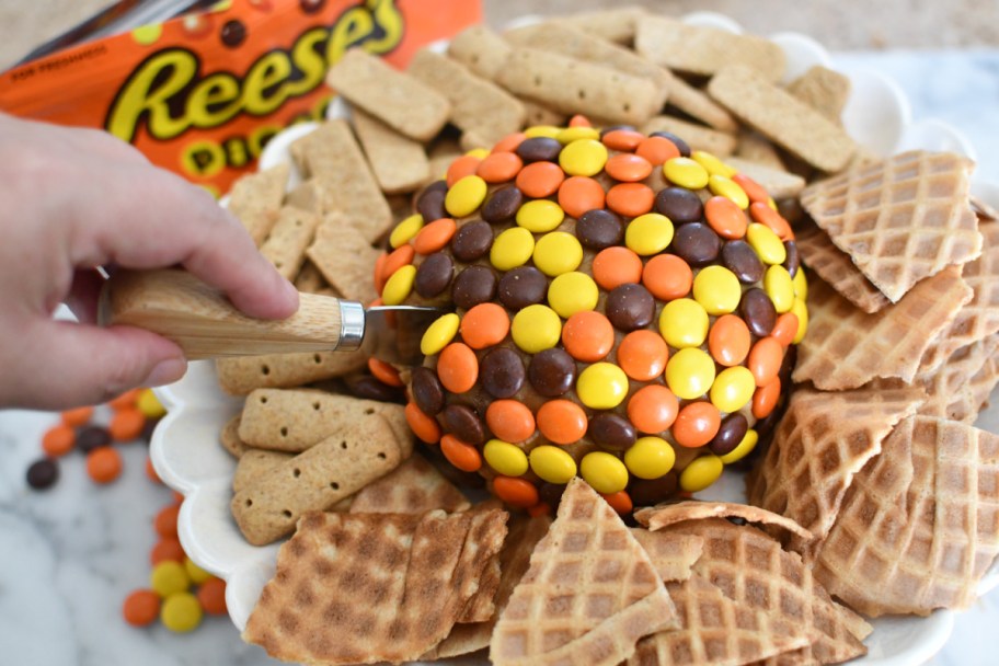 cutting into reese's peanut butter dessert ball 