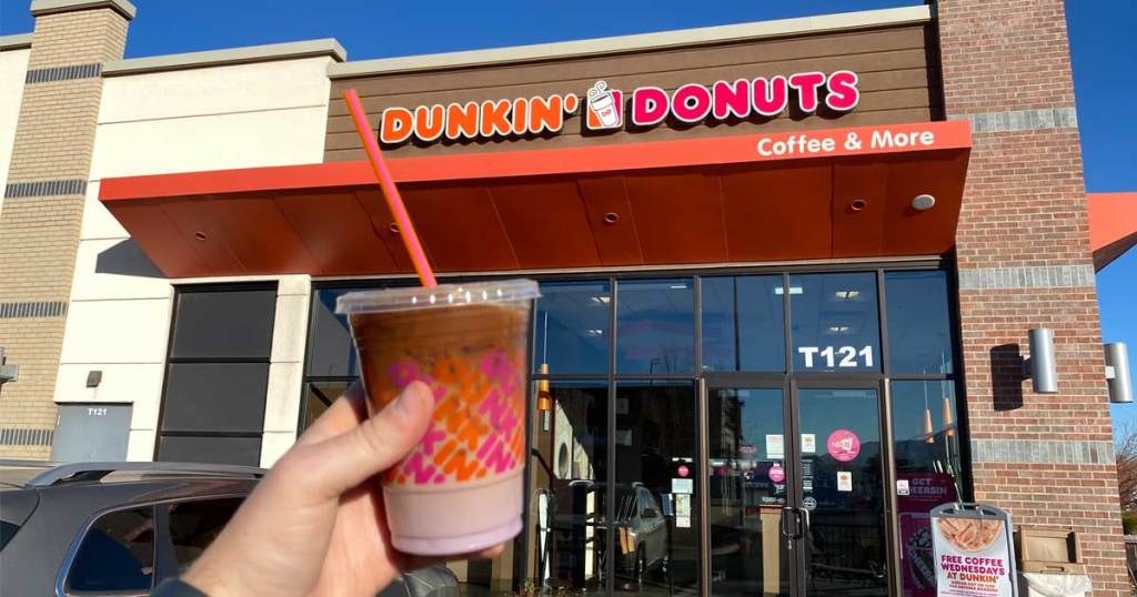 dunkin donuts drink in hand in front of store