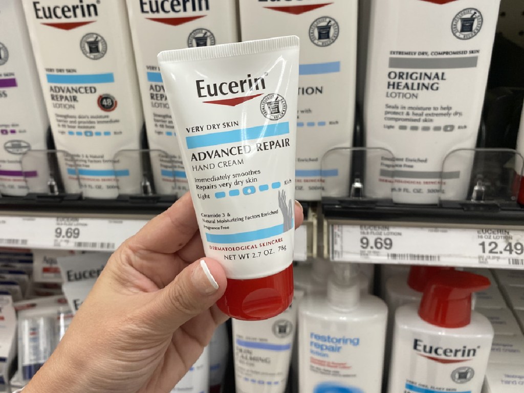 eucerin advance hand repair cream in woman's hand at store