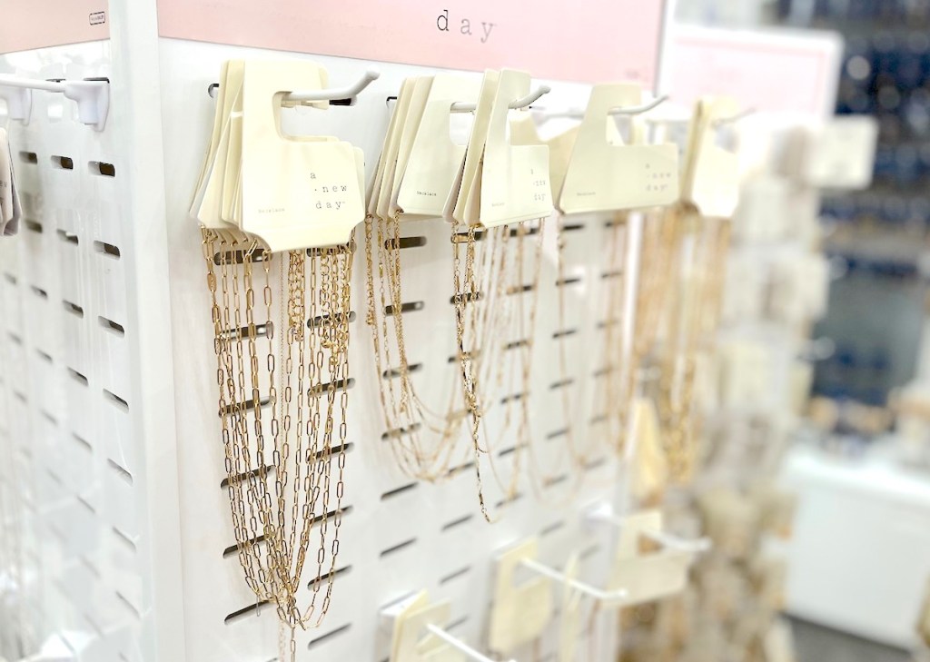 row of gold paperclip necklaces on store display