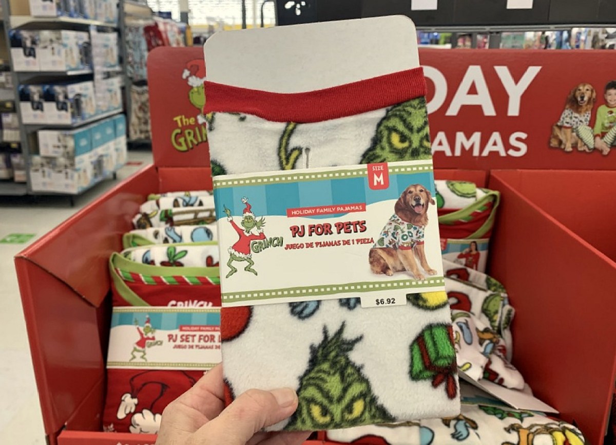 grinch dog pjs held in hand at store