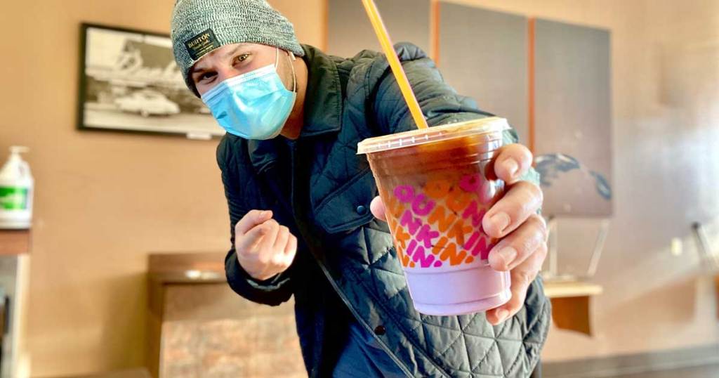 Guy with purple ombre drink at Dunkin