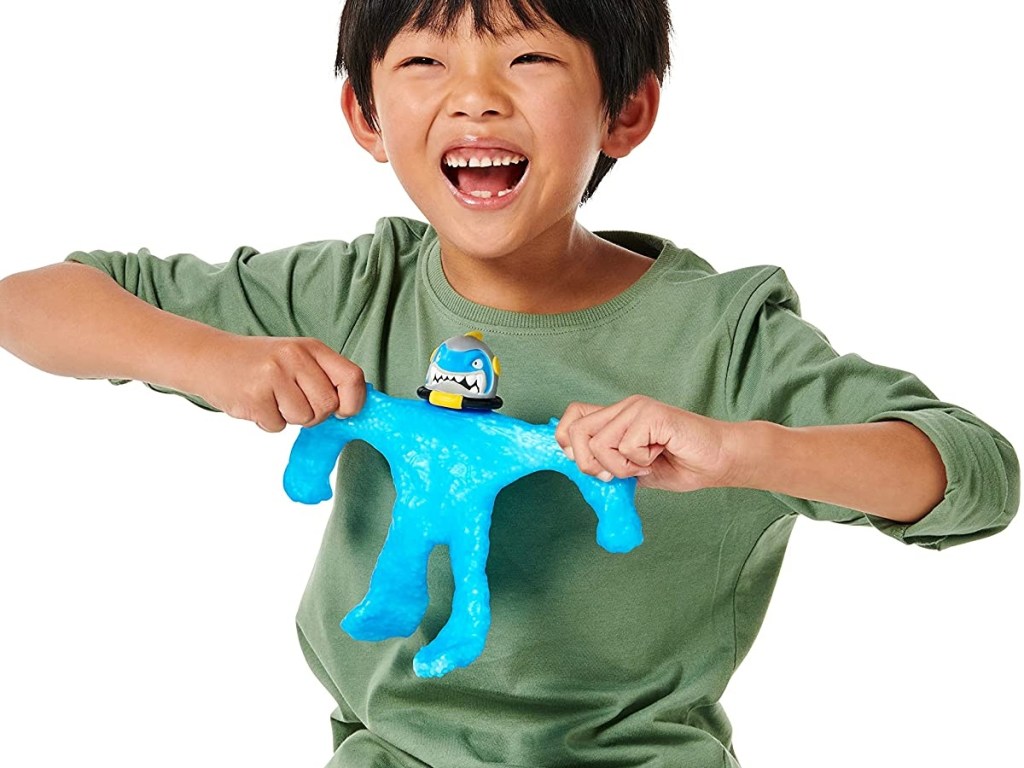 boy pulling on stretchy blue action figure