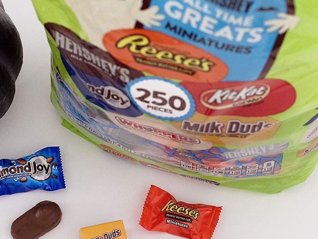 Hershey's 250-piece bag of candy with almond joy milk duds and Reese's pieces beside bag