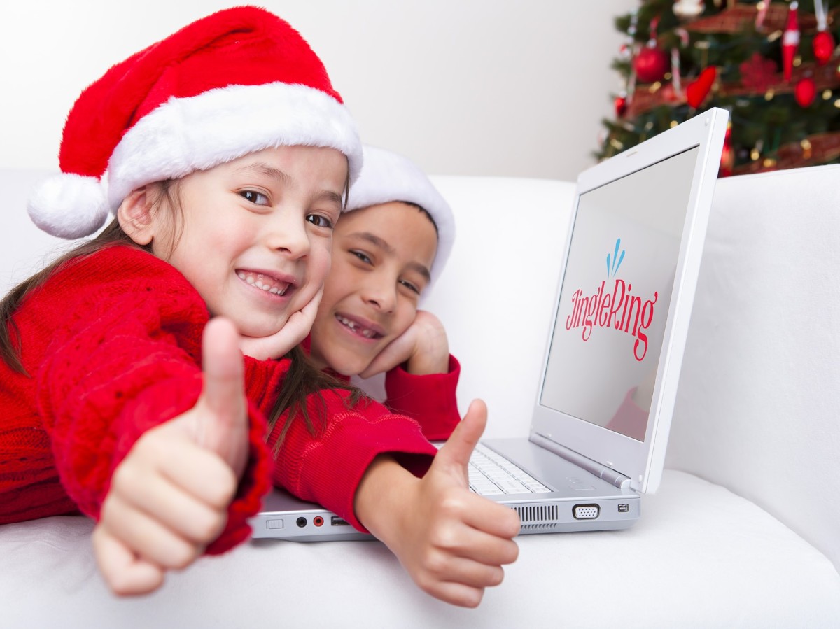 two girls in Santa hats showing thumbs up using jinglering for how to call santa