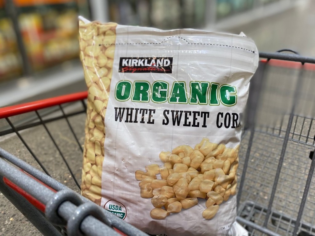 bag of frozen corn in shopping cart