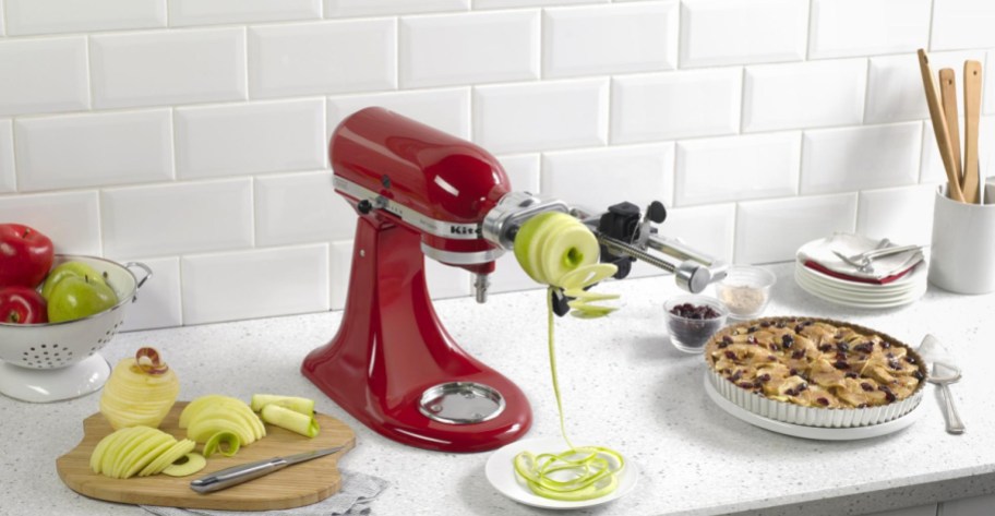 kitchenaid 5 Blade Spiralizer spiraling apple on countertop next to pie and apples sliced on cutting board